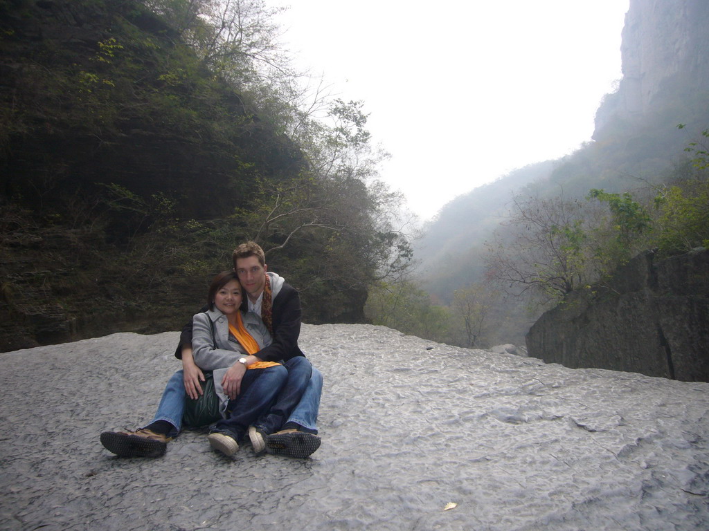 Tim and Miaomiao sitting on a rock at the Longfeng Gorge at the Mount Yuntaishan Global Geopark