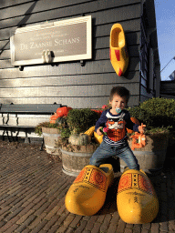 Max with wooden shoes in front of the Wooden Shoe Workshop Zaanse Schans at the Zaanse Schans neighbourhood