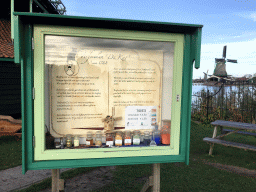 Information on the De Kat windmill at the Zaanse Schans neighbourhood, with a view on the De Os and Het Jonge Schaap windmills