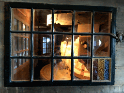 Window with grinding stones at the ground floor of the De Kat windmill at the Zaanse Schans neighbourhood