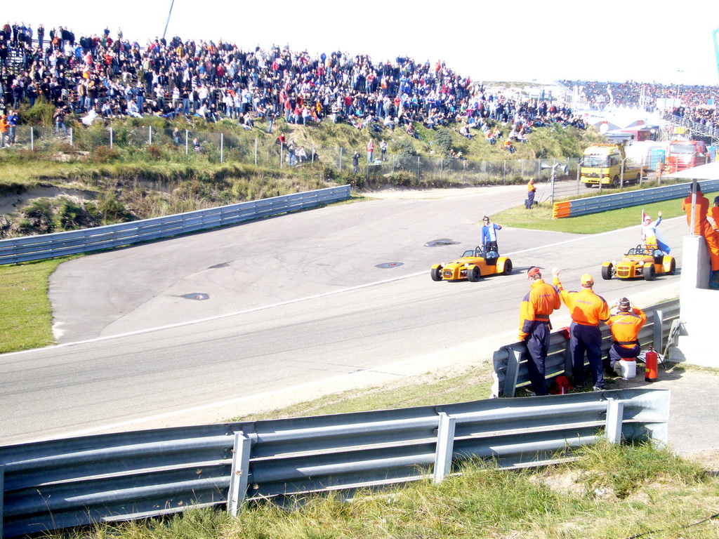 Old race cars with Jeroen Bleekemolen, another Dutch driver and Dutch flags at Circuit Zandvoort, before the Main Race of the 2007-08 Dutch A1 Grand Prix of Nations