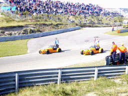Old race cars with Jeroen Bleekemolen, another Dutch driver and Dutch flags at Circuit Zandvoort, before the Main Race of the 2007-08 Dutch A1 Grand Prix of Nations