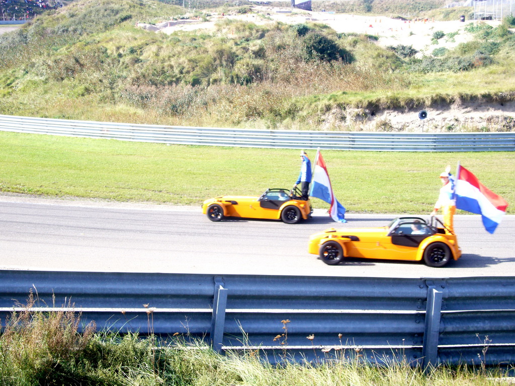 Old race cars with Jeroen Bleekemolen, another Dutch driver and Dutch flags at Circuit Zandvoort, before the Main Race of the 2007-08 Dutch A1 Grand Prix of Nations