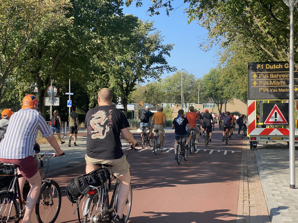 Fans biking to the parking lots of Circuit Zandvoort at the Kamerlingh Onnesstraat street