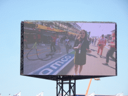 TV screen with reporter at the main straight at Circuit Zandvoort, viewed from the Eastside Grandstand 3, just before the Formula 1 Free Practice 3