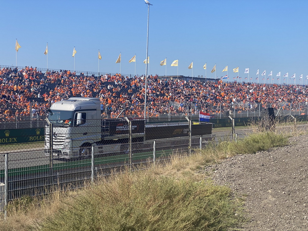 Paddock Club Truck on the straight between turns 12 and 13 and fans at the Arena Grandstand 2 and 3 at Circuit Zandvoort, during the Paddock Club Track Tour