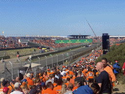 People doing the Paddock Club Tour at the straight between turns 12 and 13 and fans at the Arena-Out Grandstand and Arena Grandstands 2 and 3 at Circuit Zandvoort