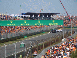 People doing the Paddock Club Tour at the straight between turns 12 and 13 and fans at the Arena Grandstands 2 and 3 at Circuit Zandvoort