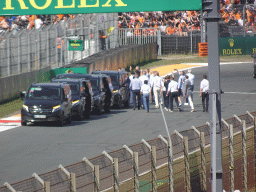 People doing the Paddock Club Tour at the straight between turns 12 and 13 and fans at the Arena Grandstand 2 at Circuit Zandvoort