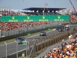 People doing the Paddock Club Tour at the straight between turns 12 and 13 and fans at the Arena Grandstands 2 and 3 at Circuit Zandvoort