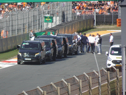 People doing the Paddock Club Tour at the straight between turns 12 and 13 and fans at the Arena Grandstand 2 at Circuit Zandvoort