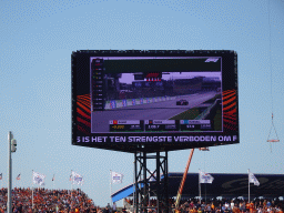 TV screen with the Formula 1 car of Carlos Sainz at the main straight at Circuit Zandvoort, viewed from the Eastside Grandstand 3, at the end of the Formula 1 Qualification Session 3
