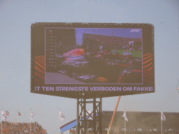 TV screen with the Formula 1 cars of Max Verstappen and Charles Leclerc at the main straight at Circuit Zandvoort, viewed from the Eastside Grandstand 3, right after the Formula 1 Qualification Session 3