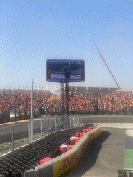 TV screen with Max Verstappen being interviewed at the main straight at Circuit Zandvoort, viewed from the Eastside Grandstand 3, right after the Formula 1 Qualification Session 3