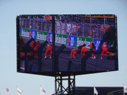 TV screen with dancers at the main straight at Circuit Zandvoort, viewed from the Eastside Grandstand 3, right after the Formula 1 Qualification Session 3