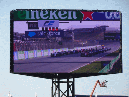 TV screen with the start of the Formula 2 Sprint Race at the main straight at Circuit Zandvoort, viewed from the Eastside Grandstand 3