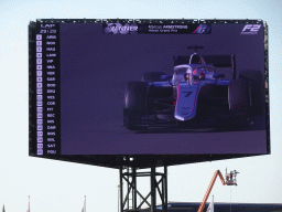 TV screen with the Formula 2 car of Marcus Armstrong at the main straight at Circuit Zandvoort, viewed from the Eastside Grandstand 3, right after the Formula 2 Sprint Race