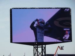 TV screen with Marcus Armstrong at the main straight at Circuit Zandvoort, viewed from the Eastside Grandstand 3, right after the Formula 2 Sprint Race