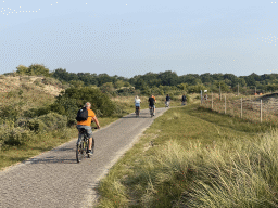 Fans biking on the Blinkertweg road through the dunes to the parking lots of Circuit Zandvoort