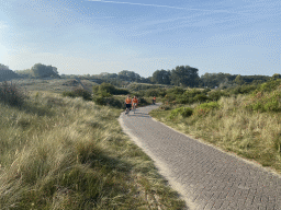 Fans biking on the Blinkertweg road through the dunes to the parking lots of Circuit Zandvoort