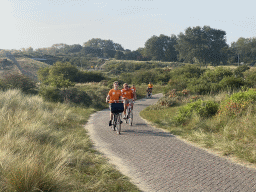 Fans biking on the Blinkertweg road through the dunes to the parking lots of Circuit Zandvoort