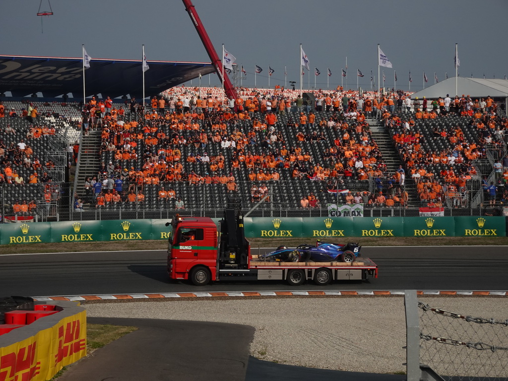 Formula 2 car of Logan Sargeant being driven away after an accident at the Hans Ernst Chicane at Circuit Zandvoort, viewed from the Eastside Grandstand 3, during the Formula 2 Feature Race