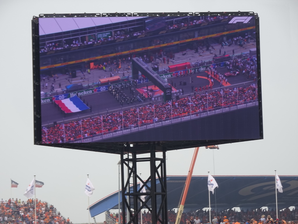 TV screen with Floor Jansen, orchestra and Formula 1 drivers at the main straight at Circuit Zandvoort, viewed from the Eastside Grandstand 3, during the pre-race show of the Formula 1 Race