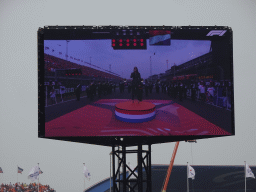 TV screen with Floor Jansen and orchestra performing the Dutch National Anthem at the main straight at Circuit Zandvoort, viewed from the Eastside Grandstand 3, during the pre-race show of the Formula 1 Race