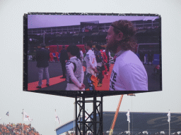 TV screen with Formula 1 drivers at the main straight at Circuit Zandvoort, viewed from the Eastside Grandstand 3, during the pre-race show of the Formula 1 Race