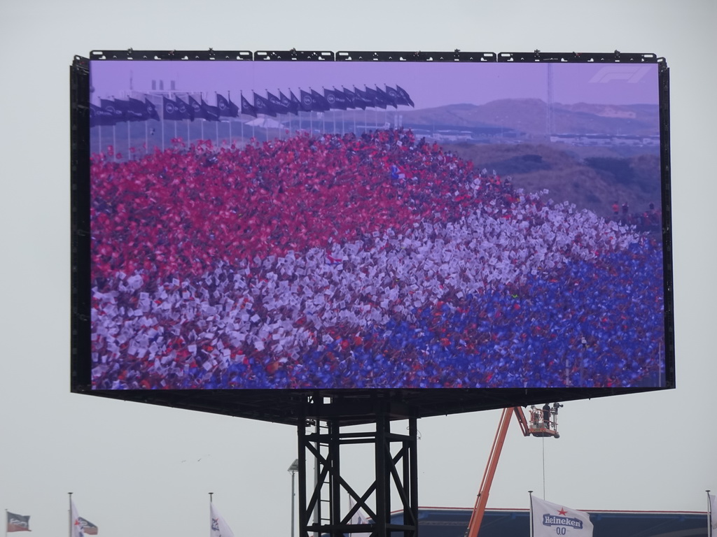 TV screen with Dutch fans at the main straight at Circuit Zandvoort, viewed from the Eastside Grandstand 3, just before the Formula 1 Race