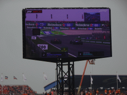 TV screen with the Formula 1 cars of Max Verstappen and George Russell at Circuit Zandvoort, viewed from the Eastside Grandstand 3, during the Formula 1 Race