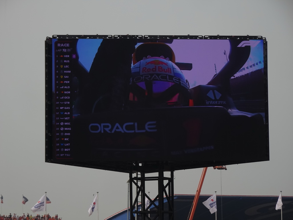 TV screen with Max Verstappen crossing the finish line at the main straight at Circuit Zandvoort, viewed from the Eastside Grandstand 3, during the Formula 1 Race