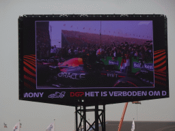 TV screen with Max Verstappen getting out of his Formula 1 car at the pit straight at Circuit Zandvoort, viewed from the Eastside Grandstand 3, right after the Formula 1 Race