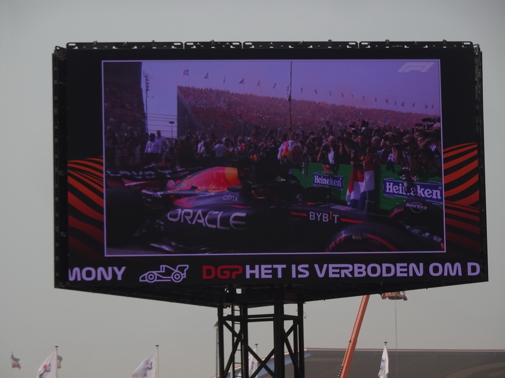 TV screen with Max Verstappen getting out of his Formula 1 car at the pit straight at Circuit Zandvoort, viewed from the Eastside Grandstand 3, right after the Formula 1 Race