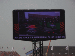 TV screen with George Russell and Max Verstappen`s Formula 1 car at the pit straight at Circuit Zandvoort, viewed from the Eastside Grandstand 3, right after the Formula 1 Race