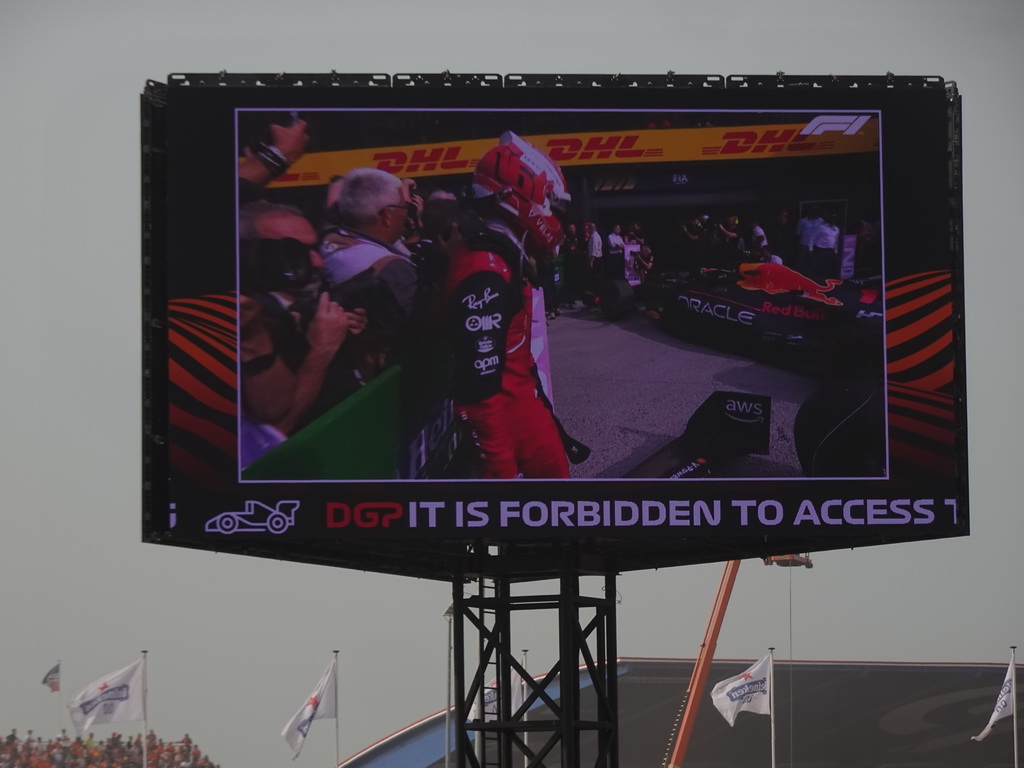 TV screen with Charles Leclerc and Max Verstappen`s Formula 1 car at the pit straight at Circuit Zandvoort, viewed from the Eastside Grandstand 3, right after the Formula 1 Race
