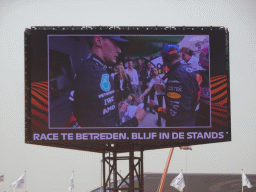TV screen with Max Verstappen and George Russell at the pit straight at Circuit Zandvoort, viewed from the Eastside Grandstand 3, right after the Formula 1 Race
