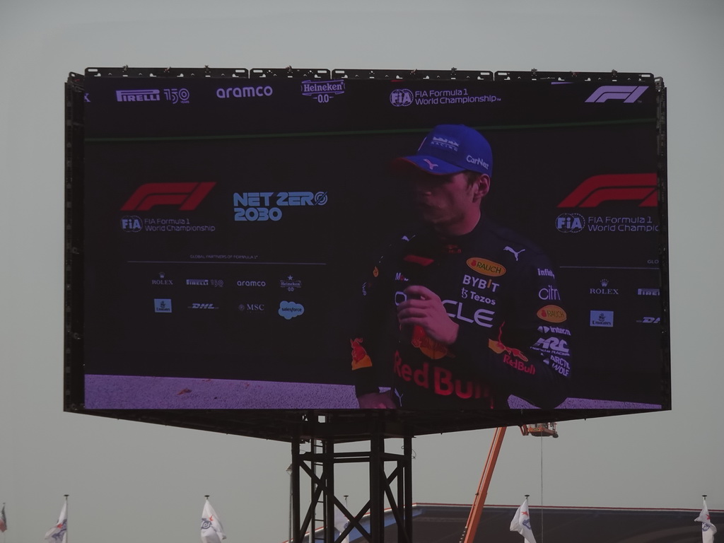 TV screen with Max Verstappen being interviewed at the pit straight at Circuit Zandvoort, viewed from the Eastside Grandstand 3, right after the Formula 1 Race