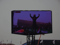 TV screen with Max Verstappen standing on his car at the pit straight at Circuit Zandvoort, viewed from the Eastside Grandstand 3, right after the Formula 1 Race