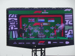 TV screen with George Russell, Max Verstappen and Charles Leclerc at the main stage at Circuit Zandvoort, viewed from the Eastside Grandstand 3, during the podium ceremony of the Formula 1 Race