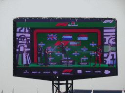 TV screen with George Russell, Max Verstappen and Charles Leclerc at the main stage at Circuit Zandvoort, viewed from the Eastside Grandstand 3, during the podium ceremony of the Formula 1 Race