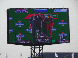 TV screen with George Russell, Max Verstappen and Charles Leclerc at the main stage at Circuit Zandvoort, viewed from the Eastside Grandstand 3, during the podium ceremony of the Formula 1 Race