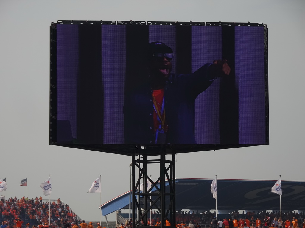 TV screen with entertainer at the main stage at Circuit Zandvoort, viewed from the Eastside Grandstand 3, during the post-race show of the Formula 1 Race