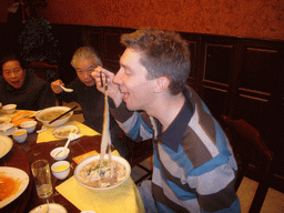 Tim and Miaomiao`s grandparents with noodles in a restaurant in the city center