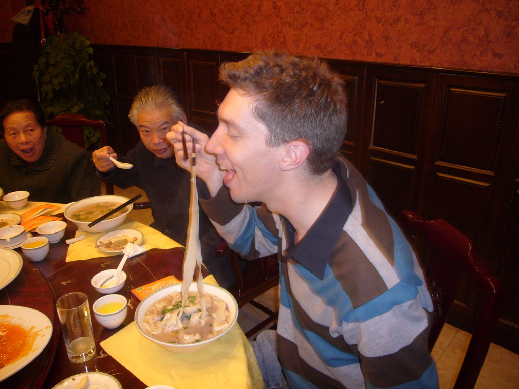 Tim and Miaomiao`s grandparents with noodles in a restaurant in the city center