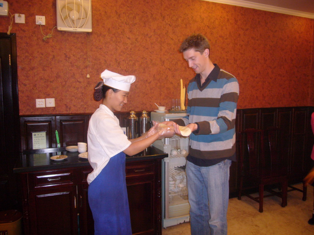 Tim and a cook making noodles in a restaurant in the city center