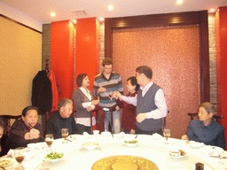 Tim, Miaomiao and Miaomiao`s parents and grandparents having drinks in a restaurant in the city center