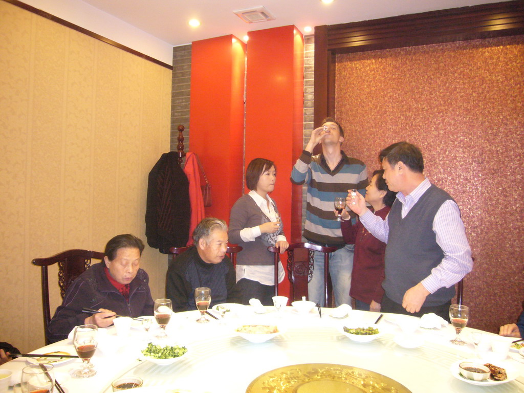 Tim, Miaomiao and Miaomiao`s parents and grandparents having drinks in a restaurant in the city center