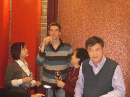 Tim, Miaomiao and Miaomiao`s parents having drinks in a restaurant in the city center