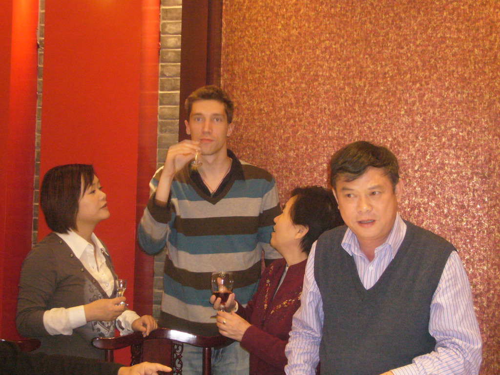 Tim, Miaomiao and Miaomiao`s parents having drinks in a restaurant in the city center